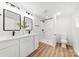 Modern bathroom with double vanity, shower with marble-look tile and black accents at 300 Cherry St, Belmont, NC 28012