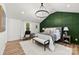 Bedroom with decorative green wall, chandelier, white rug and natural light at 300 Cherry St, Belmont, NC 28012
