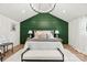Bedroom with decorative green wall, chandelier, and white rug at 300 Cherry St, Belmont, NC 28012
