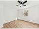 Bright, airy bedroom with light wood floors, ceiling fan, and a window at 300 Cherry St, Belmont, NC 28012