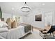 Bright bedroom with vaulted ceiling, statement chandelier, and lots of pillows at 300 Cherry St, Belmont, NC 28012