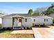 Charming home featuring a welcoming front porch, well-maintained landscaping, and a freshly sealed driveway at 300 Cherry St, Belmont, NC 28012