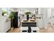 Bright kitchen with white cabinets, stainless steel appliances and a butcher block island at 300 Cherry St, Belmont, NC 28012