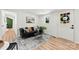 Living room featuring a black sofa, neutral rug, and light wood floors, filled with natural light at 300 Cherry St, Belmont, NC 28012