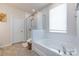 Clean bathroom featuring a soaking tub and glass enclosed shower with white tiles and neutral paint at 3100 Cheyney Park Dr, Charlotte, NC 28269