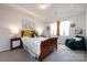 Bright bedroom with tray ceiling featuring a wooden bedframe, decorative accents, and carpet flooring at 3100 Cheyney Park Dr, Charlotte, NC 28269