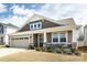 Charming home with a two-car garage, stone accents, covered porch, and beautifully landscaped front yard at 3100 Cheyney Park Dr, Charlotte, NC 28269