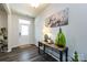 Inviting hallway with wood-look floors, modern decor, and ample natural light, leading into the home at 3100 Cheyney Park Dr, Charlotte, NC 28269