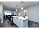 Kitchen island with sink offers seating and integrates seamlessly with the open living space at 3100 Cheyney Park Dr, Charlotte, NC 28269