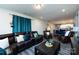 Comfortable living room featuring a sectional sofa, coffee table, and seamless flow to the kitchen at 3100 Cheyney Park Dr, Charlotte, NC 28269