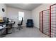 Simple office space with a dark desk and chair, room divider, and carpet flooring at 3100 Cheyney Park Dr, Charlotte, NC 28269