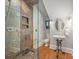 Charming bathroom with modern shower, unique sink with wrought iron stand, and hardwood floors at 3201 Oak Brook Dr, Waxhaw, NC 28173