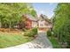 Beautiful exterior of a home with lush landscaping and a long driveway at 3201 Oak Brook Dr, Waxhaw, NC 28173