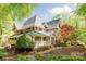 Charming exterior with a covered porch, lush landscaping, and a well-maintained lawn at 3201 Oak Brook Dr, Waxhaw, NC 28173