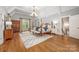 Spacious main bedroom with hardwood floors, vaulted ceilings, a four-poster bed, and a chandelier at 3201 Oak Brook Dr, Waxhaw, NC 28173
