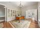 Home office featuring hardwood floors, a large bookshelf, and a wooden desk with an overhead light at 3201 Oak Brook Dr, Waxhaw, NC 28173