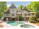 Stunning rear exterior showcasing a sparkling pool, balconies, and a charming screened-in porch at 3201 Oak Brook Dr, Waxhaw, NC 28173