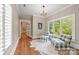 Bright sitting room with hardwood floors, large windows, and two blue-and-white plaid chairs with a side table at 3201 Oak Brook Dr, Waxhaw, NC 28173