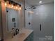 Updated bathroom featuring a walk-in shower with subway tile, a modern vanity, and stylish fixtures at 351 Glenwood Dr, Mooresville, NC 28115