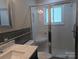 Bathroom featuring marble vanity, stylish sink, and glass enclosed shower at 351 Glenwood Dr, Mooresville, NC 28115