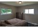 Serene bedroom with soft lighting, two sunny windows, hardwood floors, and earth tone accents at 351 Glenwood Dr, Mooresville, NC 28115