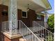 Close-up of a front porch with decorative columns, white railings, and a hanging porch light at 351 Glenwood Dr, Mooresville, NC 28115