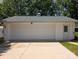 Detached white garage with green roof, featuring a three-car door and a side entrance at 351 Glenwood Dr, Mooresville, NC 28115