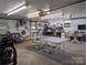 Well-lit garage with ping pong table, work benches, and plenty of room for projects and storage at 351 Glenwood Dr, Mooresville, NC 28115