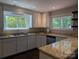 Bright kitchen featuring white cabinets, granite countertops, stainless sink, and lots of natural light at 351 Glenwood Dr, Mooresville, NC 28115