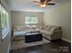 Living room featuring a sectional couch, light walls, a ceiling fan, and lots of natural light at 351 Glenwood Dr, Mooresville, NC 28115