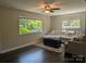 Sunlit living room with a comfy sectional sofa, hardwood floors, and ample windows at 351 Glenwood Dr, Mooresville, NC 28115