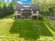 Aerial view of a home with a large, green lawn, trees, and a partial view of the home's architecture at 401 Yorkfield Dr, Shelby, NC 28150