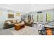 Spacious basement with comfortable seating, and a view into an adjacent living area with large windows and a bookcase at 401 Yorkfield Dr, Shelby, NC 28150