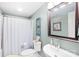 Small bathroom with a white shower curtain, toilet, vanity, mirror, and decorative wall hangings at 401 Yorkfield Dr, Shelby, NC 28150