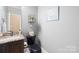 Half bathroom featuring a dark vanity and toilet, granite countertops, and stylish decorations at 401 Yorkfield Dr, Shelby, NC 28150