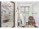 Tiled shower with built-in bench and niche, complemented by a decorative floor-length mirror and chair at 401 Yorkfield Dr, Shelby, NC 28150