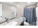 Bathroom with gray countertop, modern sink, and shower with blue curtain at 401 Yorkfield Dr, Shelby, NC 28150