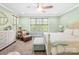 Light-filled bedroom with soft colors, offering a serene retreat with a sitting area and dresser at 401 Yorkfield Dr, Shelby, NC 28150