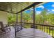 Cozy covered deck with wooded views, string lights, ceiling fan, and plenty of seating at 401 Yorkfield Dr, Shelby, NC 28150