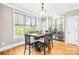 Sunlit dining room with hardwood floors and views of the outdoors through large windows at 401 Yorkfield Dr, Shelby, NC 28150