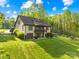 Beautiful home exterior with manicured lawn, mature trees, a large deck, and an attached garage at 401 Yorkfield Dr, Shelby, NC 28150