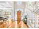 Bright foyer features a hardwood floor and a staircase with white risers and wood handrail at 401 Yorkfield Dr, Shelby, NC 28150
