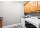 Well-lit laundry room featuring a new washer and dryer with storage cabinets at 401 Yorkfield Dr, Shelby, NC 28150
