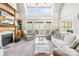 Spacious living room with a fireplace, custom built-ins, and access to the outdoor patio at 401 Yorkfield Dr, Shelby, NC 28150