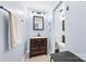 Cozy bathroom featuring a vanity with a mirror and modern fixtures over granite countertop with light-blue painted walls at 4605 Hedgemore Dr # I, Charlotte, NC 28209