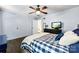Comfortable bedroom showcasing a checkered blanket, ceiling fan, and a sliding door closet with a television at 4605 Hedgemore Dr # I, Charlotte, NC 28209