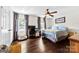 Inviting bedroom featuring a large window with curtains, desk with computer, and dark hardwood floors at 4605 Hedgemore Dr # I, Charlotte, NC 28209