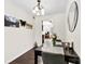 Bright dining room with dark wood table and chairs illuminated by modern chandelier and decorated with scenic art at 4605 Hedgemore Dr # I, Charlotte, NC 28209