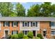Attractive townhome with brick and neutral siding and manicured landscaping at 4605 Hedgemore Dr # I, Charlotte, NC 28209