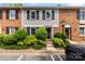 Charming townhome featuring a brick and siding exterior with well-maintained landscaping and black shutters at 4605 Hedgemore Dr # I, Charlotte, NC 28209